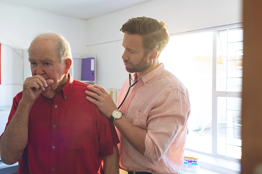 Doctor uses a stethoscope to listen to the lungs of a Vietnam veteran who was exposed to Agent Orange 