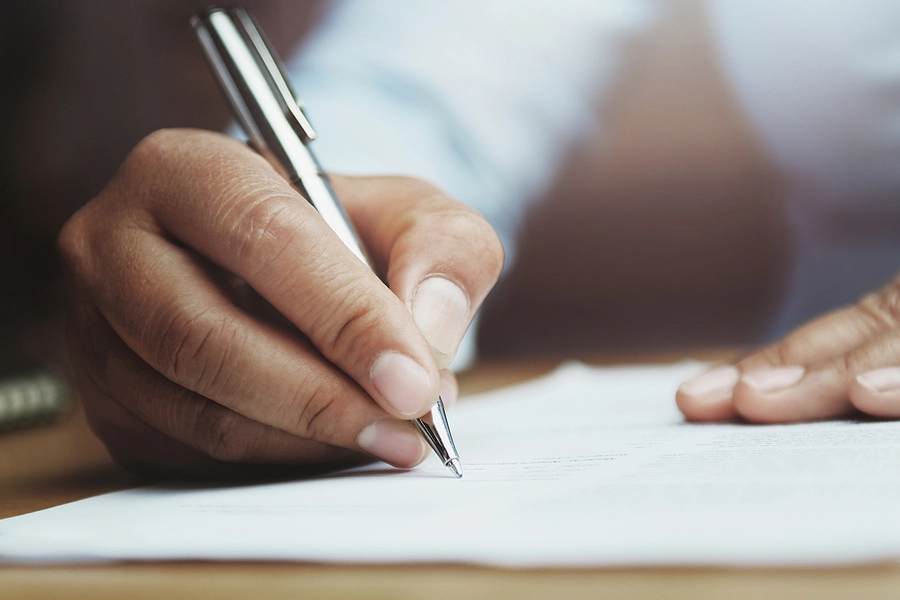 female florida veteran filling out a disability claim appeal by hand