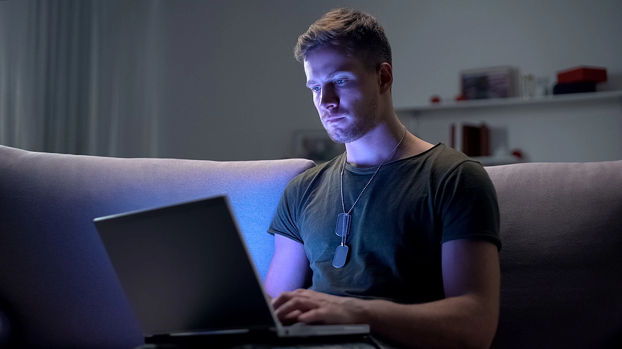 veteran at home on his laptop searching for the best VA disability attorney near him to represent his claim