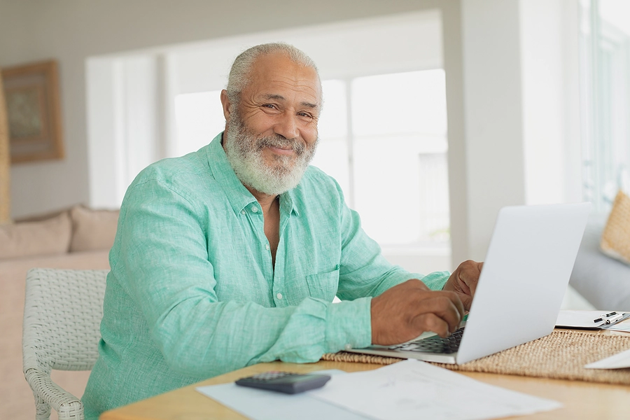 older male veteran at home using a va disability calculator to figure out his combined rating for benefits