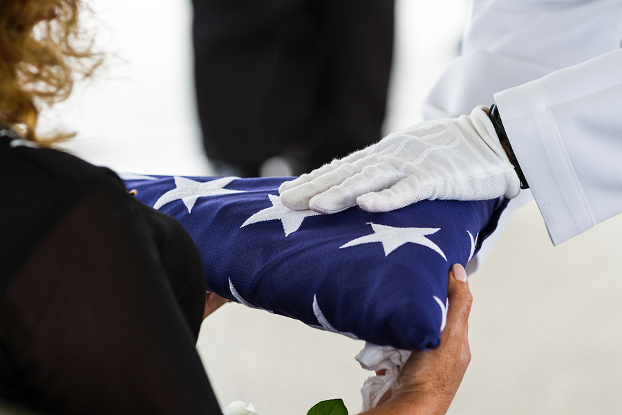 Military Funeral Handing The Flag - Dependency and Indemnity Compensation (DIC) Claims - BLG