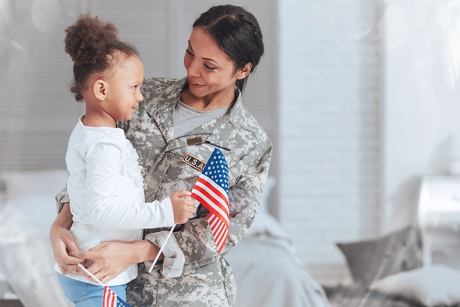 female texas veteran with a service-connected disability holding her young daughter