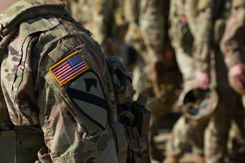 us soldier with american flag patch - SMC Benefits for Veterans - Bartlett Legal Group